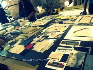 Laying out the pictures of furniture, fabric before gluing them onto the mood board.